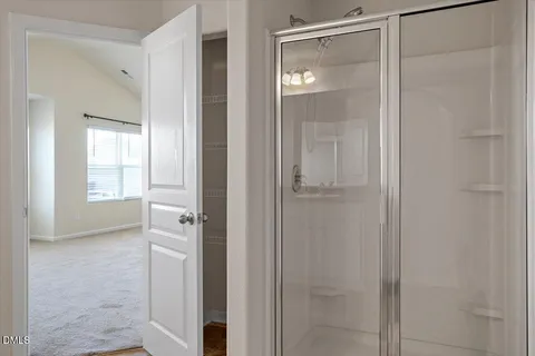 a view of bathroom with a glass door shower