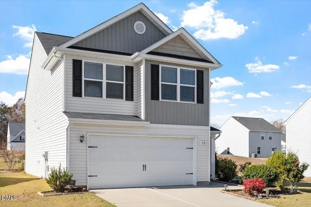 a front view of a house with a garage