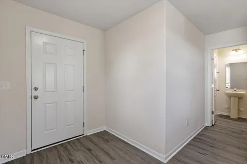 a view of a room with wooden floor