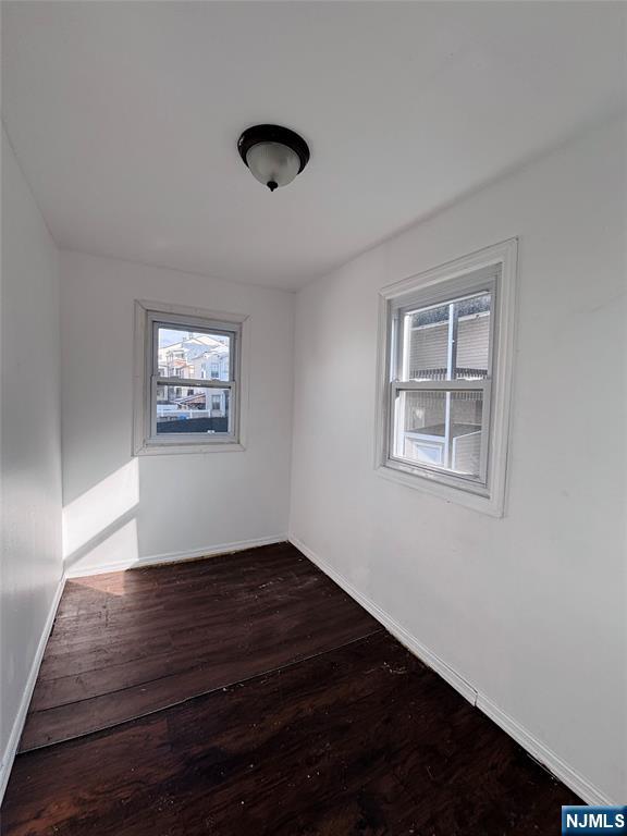 9 Sparrow Street Paterson, NJ 07524 - Photo 13 of 20 a view of an empty room with wooden floor and a window