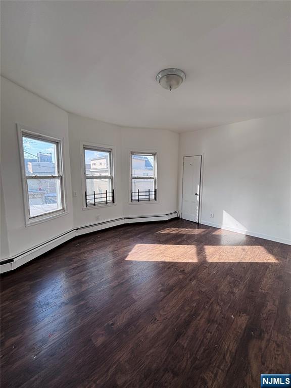 9 Sparrow Street Paterson, NJ 07524 - Photo 16 of 20 an empty room with wooden floor and windows