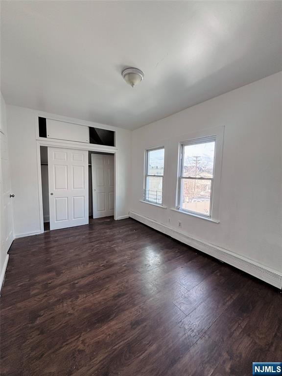 9 Sparrow Street Paterson, NJ 07524 - Photo 18 of 20 an empty room with wooden floor and windows
