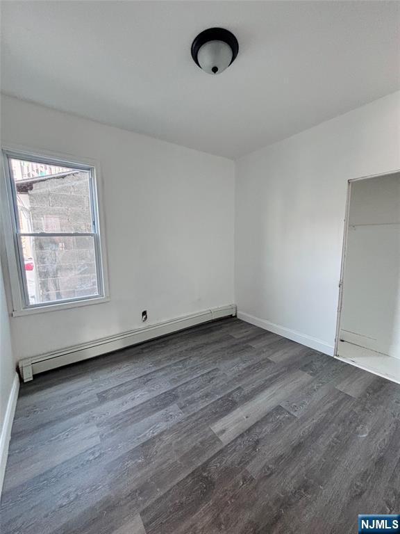 9 Sparrow Street Paterson, NJ 07524 - Photo 8 of 20 an empty room with wooden floor and windows