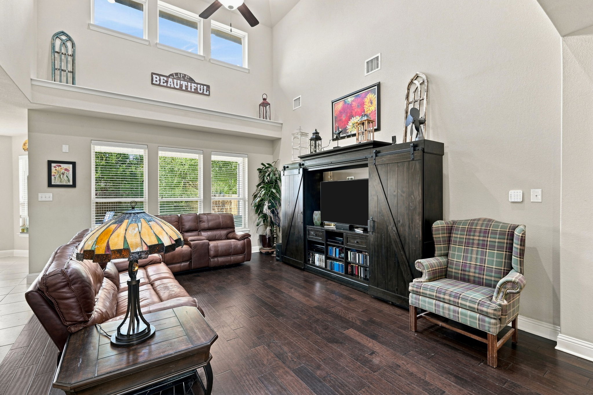 3237 Hidalgo Loop Round Rock, TX 78665 - Photo 7 of 31 Towering ceilings and rich hardwood flooring define this open, airy living space.