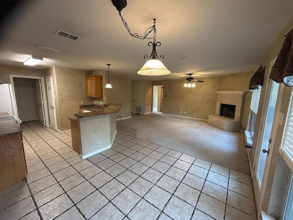 616 North Ave C Springtown, TX 76082 - Photo 13 of 13 a view of a kitchen with a sink and dishwasher a refrigerator with wooden floor