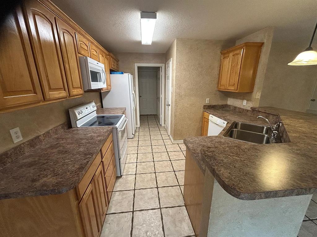 616 North Ave C Springtown, TX 76082 - Photo 3 of 13 a kitchen with stainless steel appliances granite countertop a sink stove and cabinets