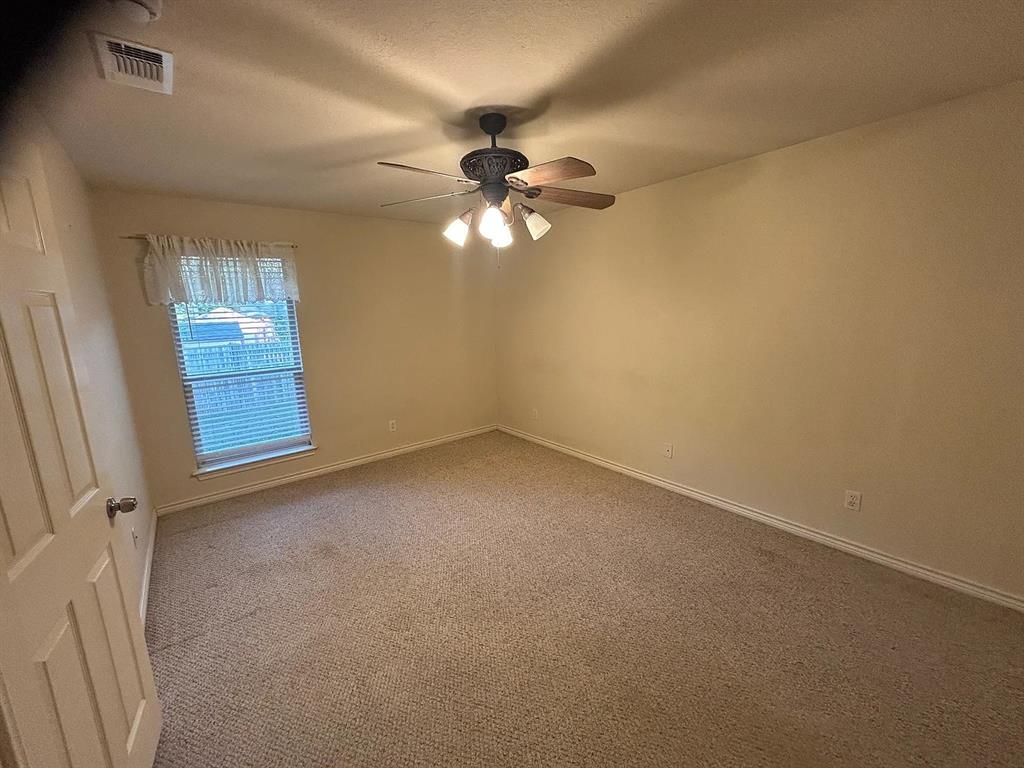 616 North Ave C Springtown, TX 76082 - Photo 4 of 13 an empty room with windows and fan