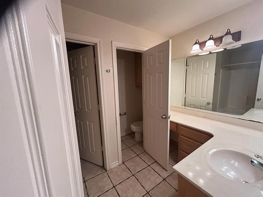 616 North Ave C Springtown, TX 76082 - Photo 5 of 13 a bathroom with a sink a toilet and shower