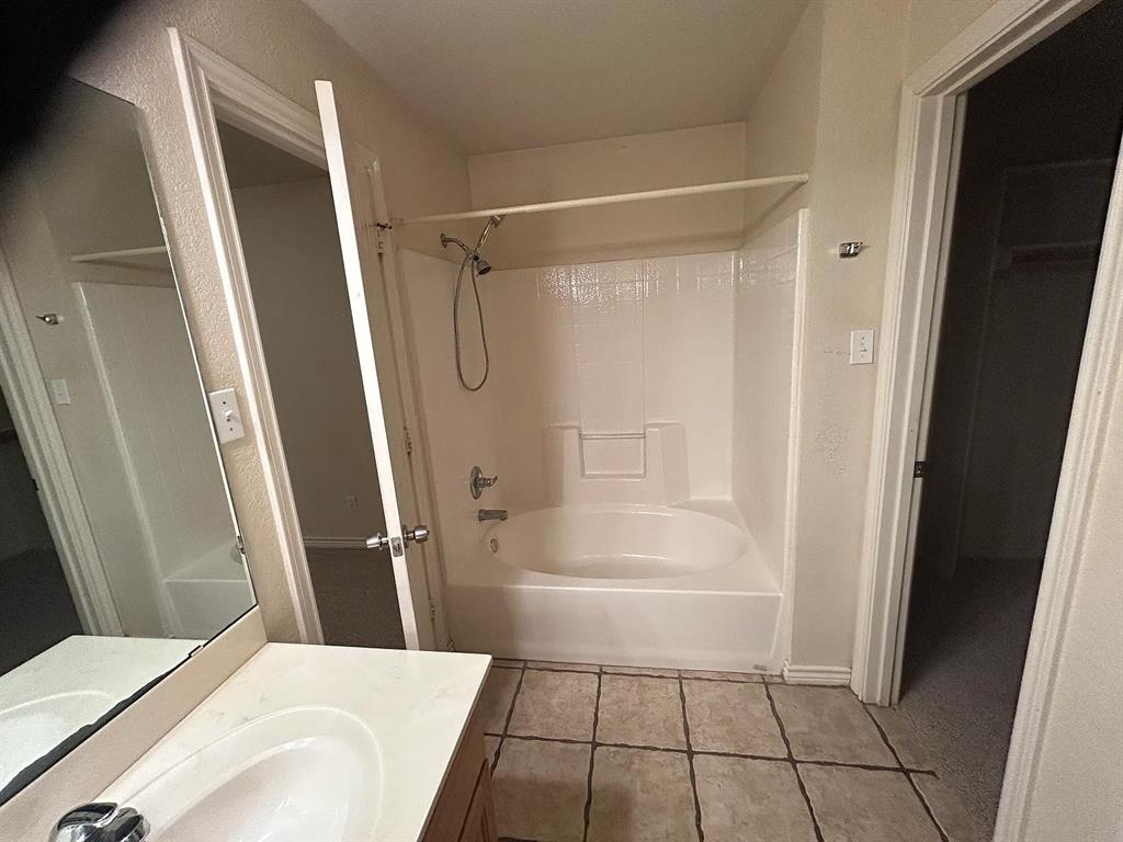 616 North Ave C Springtown, TX 76082 - Photo 6 of 13 a bathroom with a bathtub and a shower