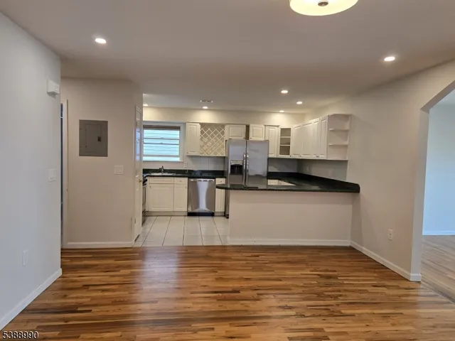 a kitchen with stainless steel appliances granite countertop a sink counter space and cabinets