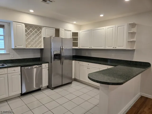a kitchen with stainless steel appliances a sink and cabinets