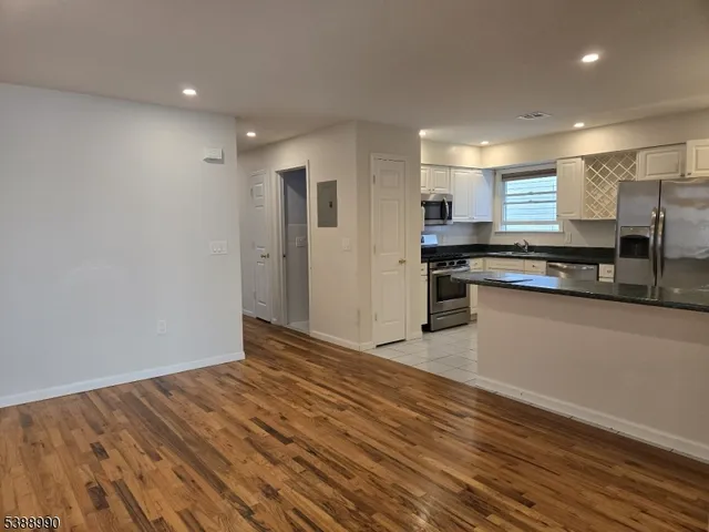 a kitchen with stainless steel appliances granite countertop a stove and a refrigerator