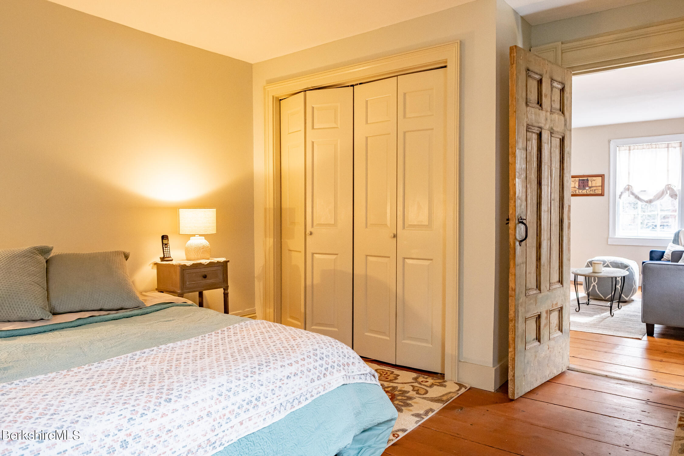 132 Sandisfield Road Sandisfield, MA 01255 - Photo 13 of 32 a bedroom with a bed and wooden floor