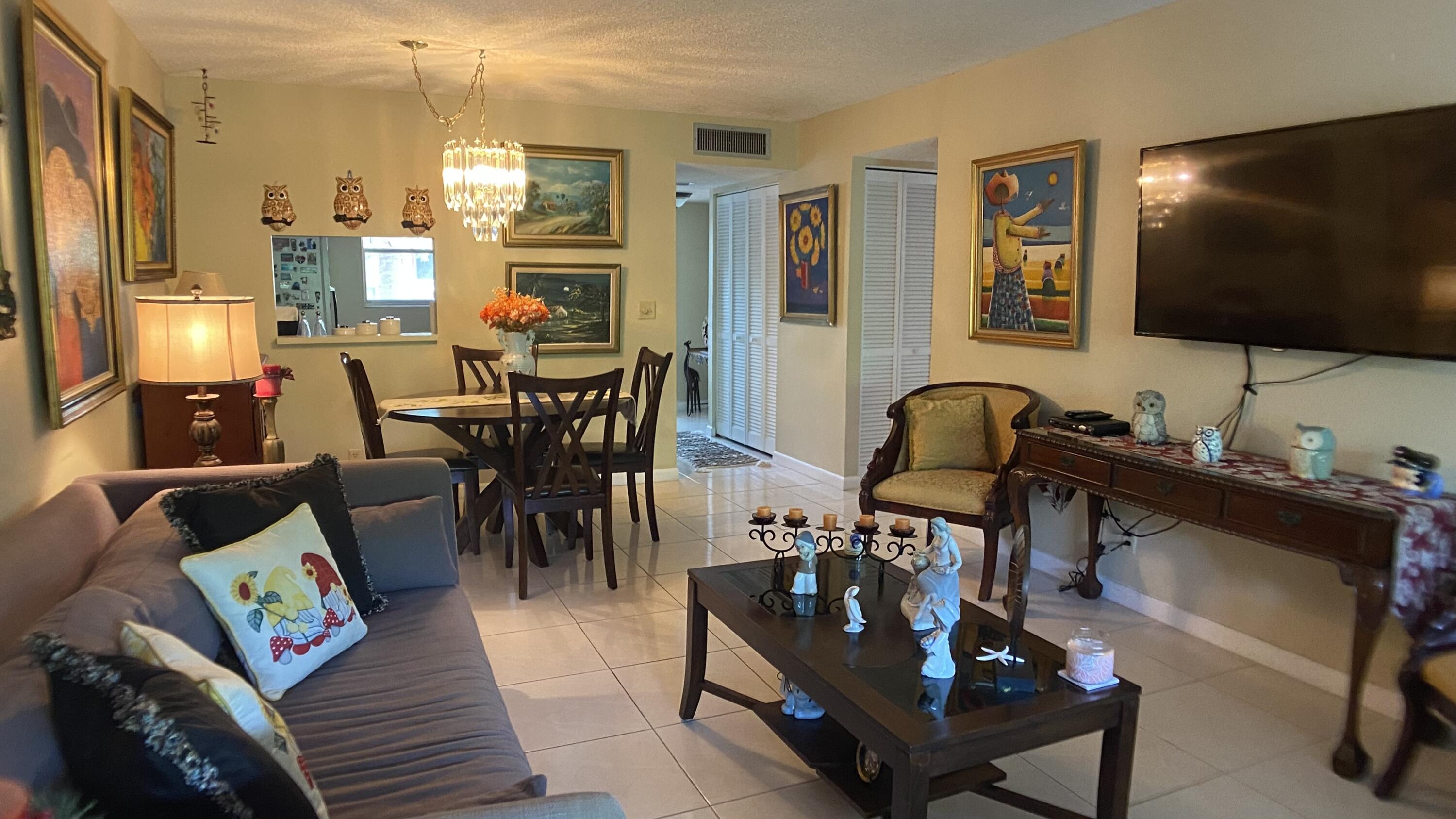 3070 Holiday Springs Boulevard, Unit 201 Margate, FL 33063 - Photo 11 of 30 a living room with furniture and a flat screen tv
