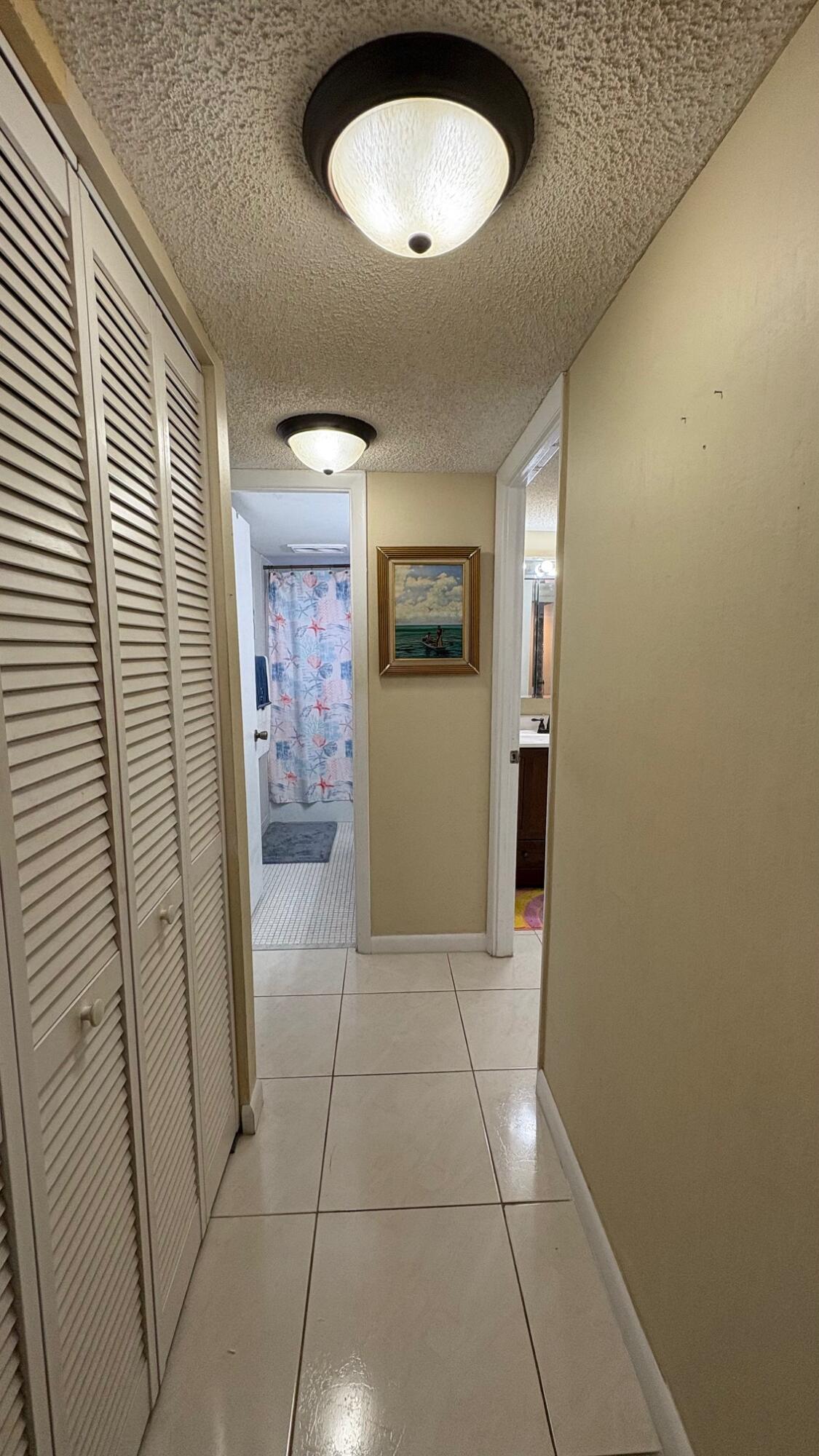 3070 Holiday Springs Boulevard, Unit 201 Margate, FL 33063 - Photo 13 of 30 a view of hallway with a window and a bathroom