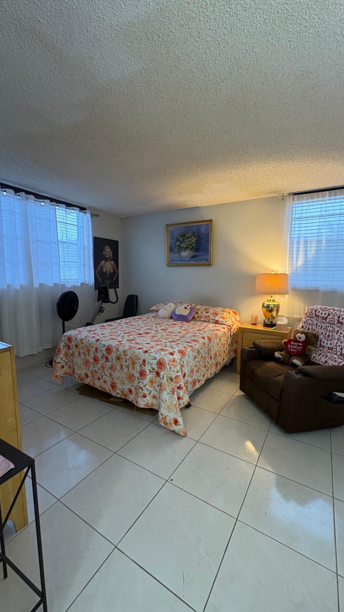 3070 Holiday Springs Boulevard, Unit 201 Margate, FL 33063 - Photo 15 of 30 a bedroom with a bed and a window