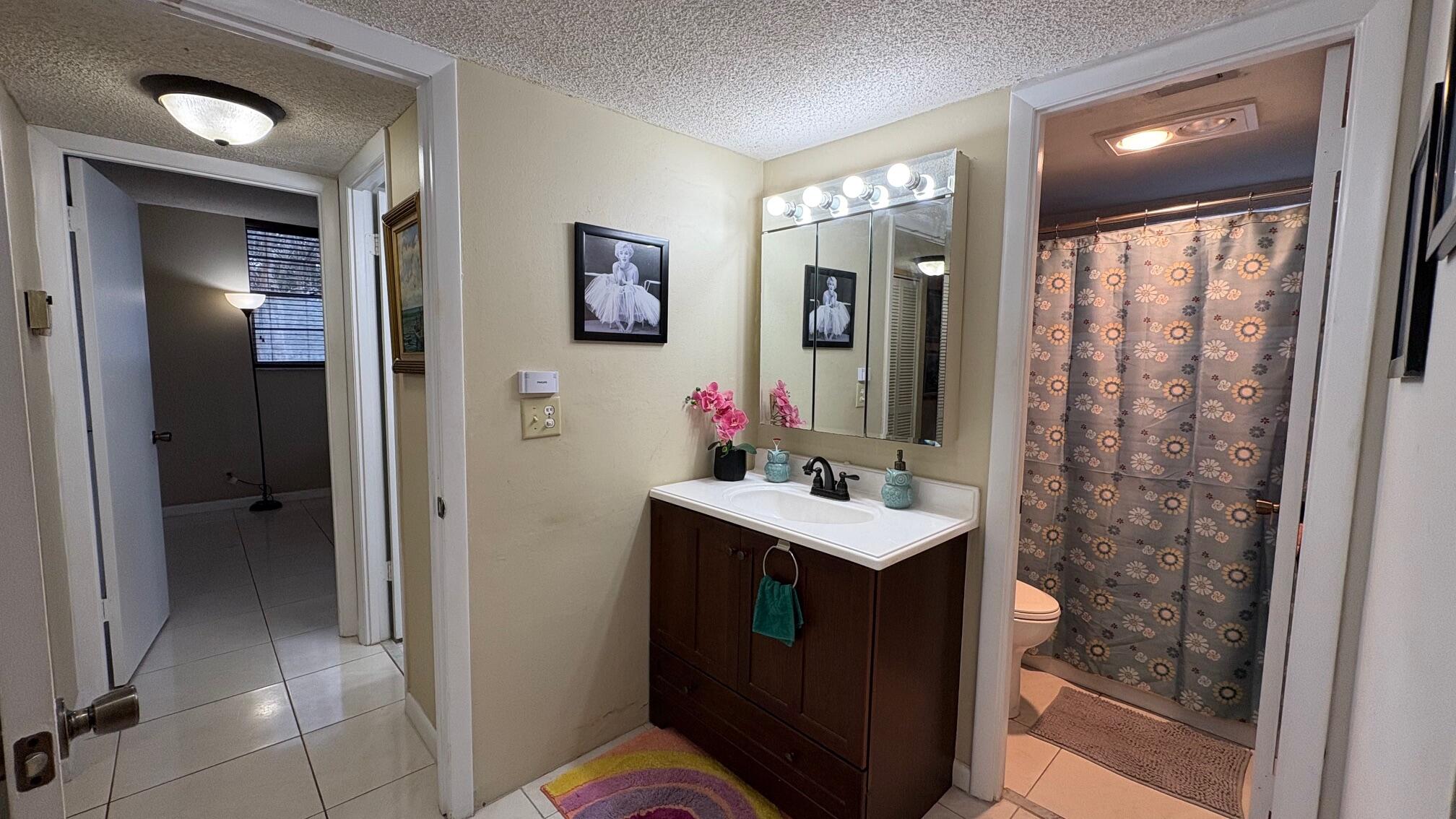 3070 Holiday Springs Boulevard, Unit 201 Margate, FL 33063 - Photo 16 of 30 a bathroom with a sink vanity mirror and toilet