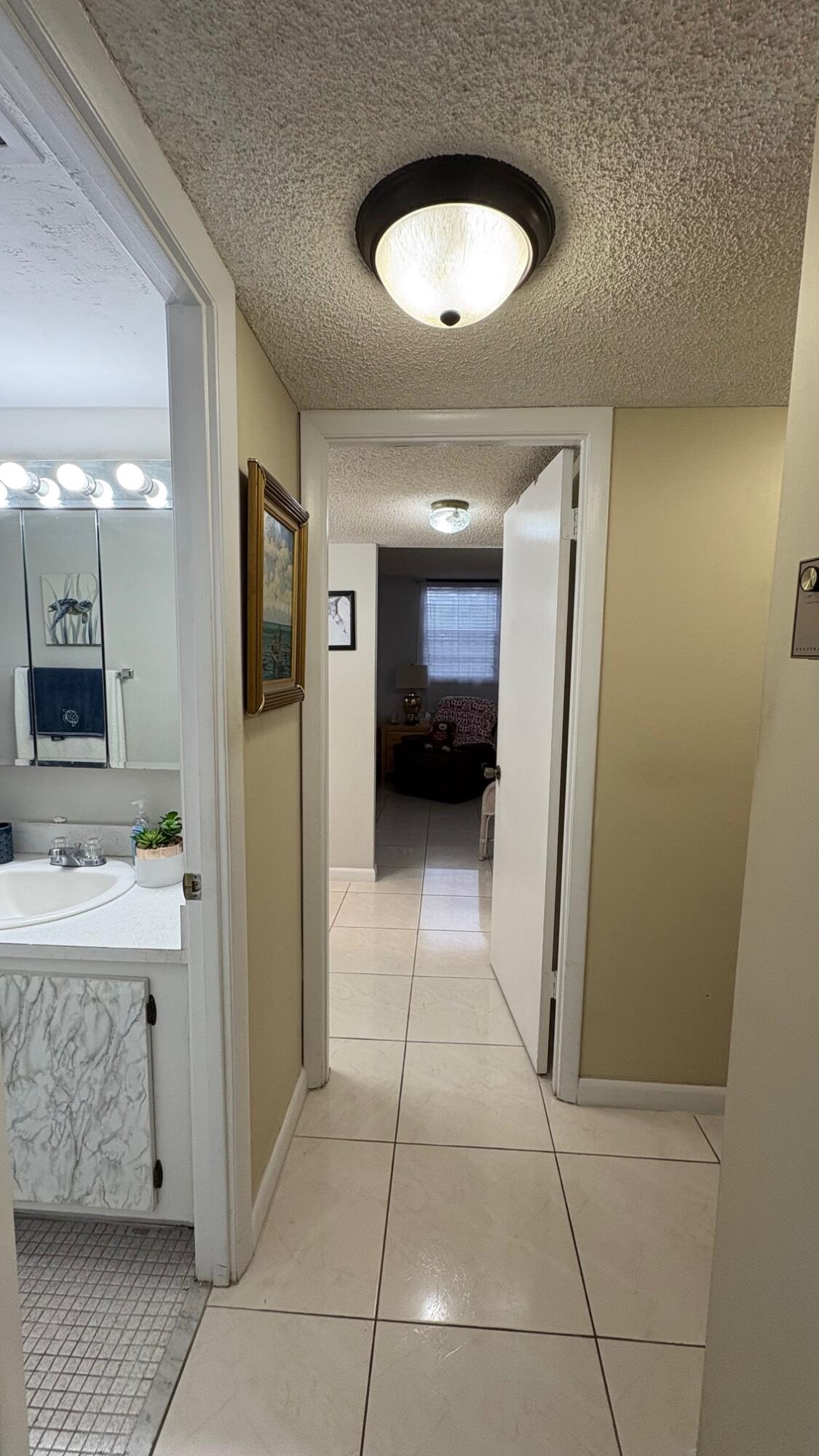 3070 Holiday Springs Boulevard, Unit 201 Margate, FL 33063 - Photo 18 of 30 a bathroom with a sink a toilet and mirror