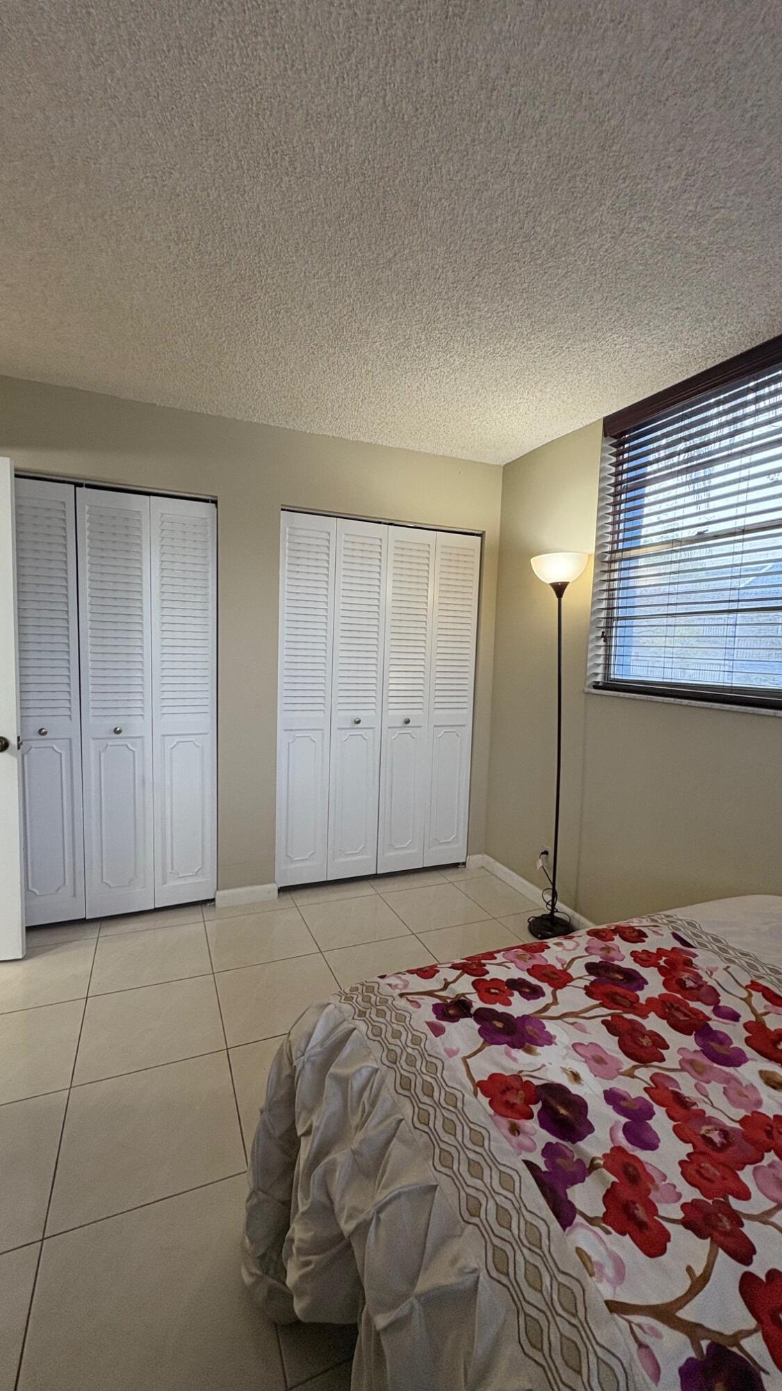 3070 Holiday Springs Boulevard, Unit 201 Margate, FL 33063 - Photo 21 of 30 a bedroom with a bed and a window