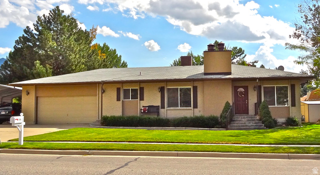 2156 East Falcon Way Sandy, UT 84093 - Photo 1 of 1 Single story home with a front yard, a chimney, driveway, an attached garage, and a porch