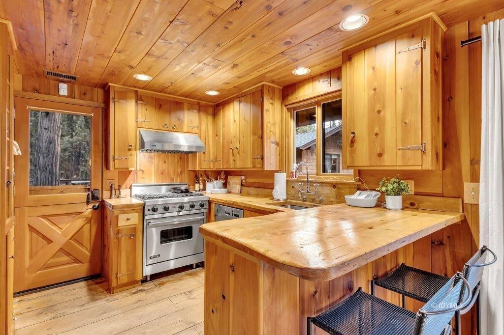 24631 Upper Rim Rock Road Idyllwild, CA 92549 - Photo 12 of 34 a kitchen with a stove a sink and a refrigerator