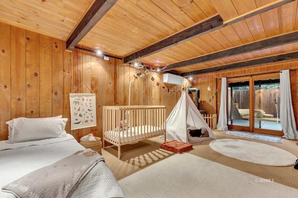 24631 Upper Rim Rock Road Idyllwild, CA 92549 - Photo 19 of 34 a bedroom with furniture and a wooden floor