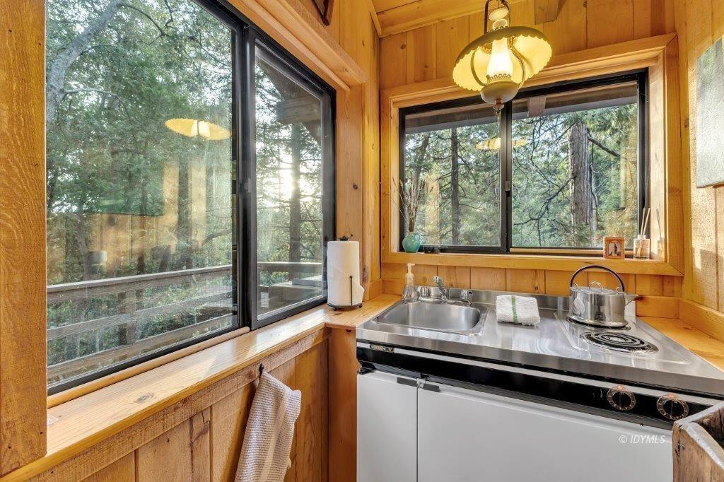24631 Upper Rim Rock Road Idyllwild, CA 92549 - Photo 26 of 34 a kitchen view with a sink and large windows