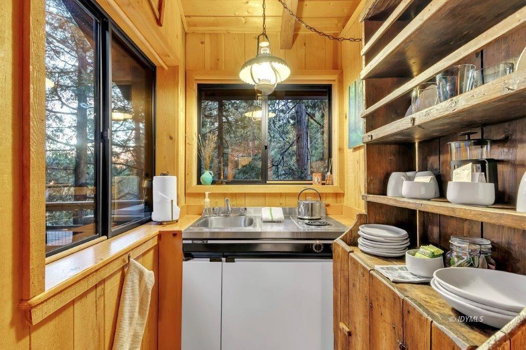 24631 Upper Rim Rock Road Idyllwild, CA 92549 - Photo 27 of 34 a kitchen view of a dining table chairs and chandelier