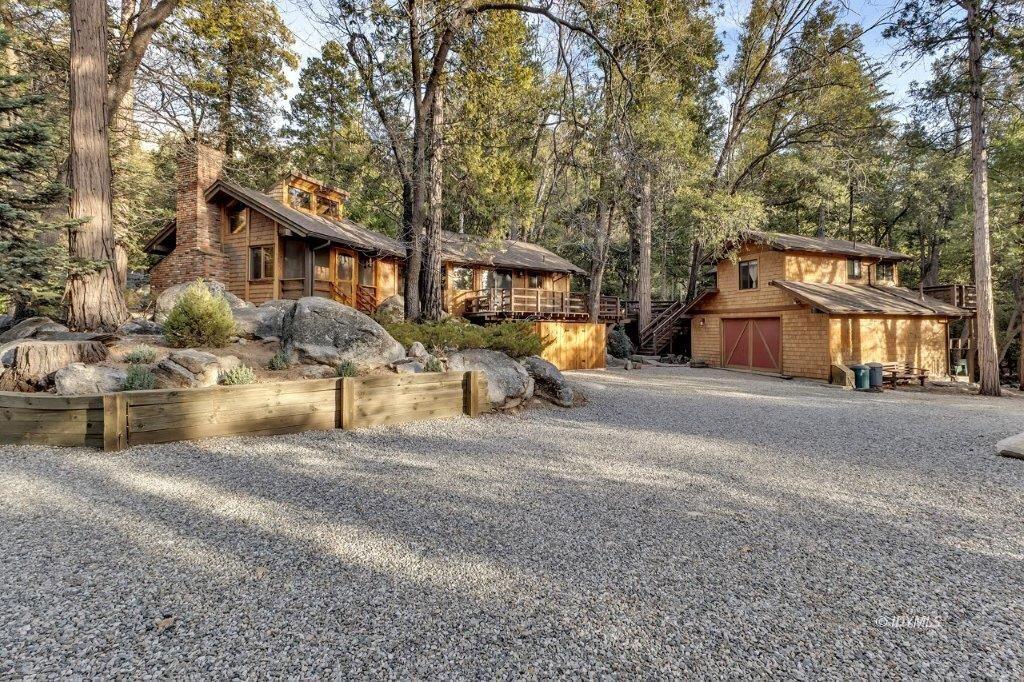 24631 Upper Rim Rock Road Idyllwild, CA 92549 - Photo 3 of 34 a front view of a house with a yard and garage