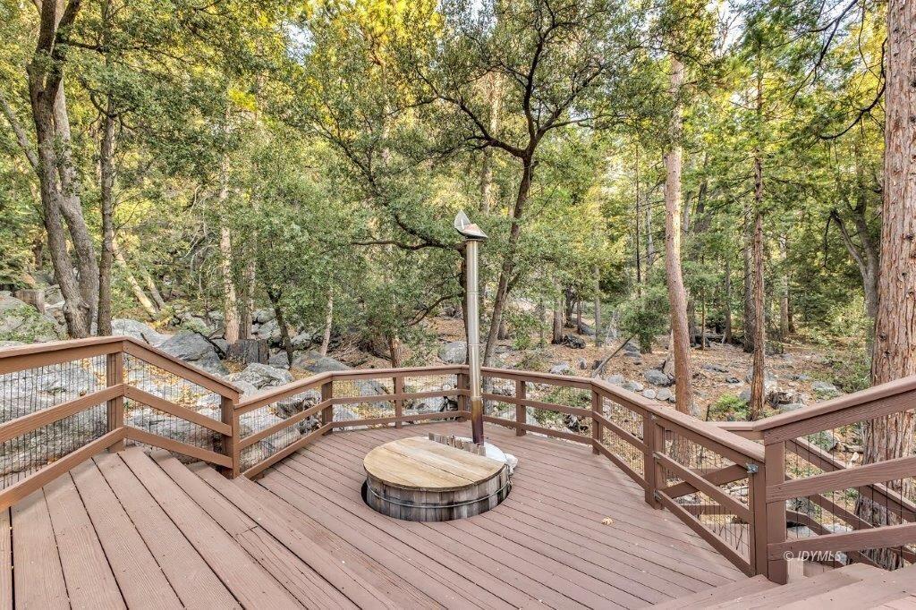 24631 Upper Rim Rock Road Idyllwild, CA 92549 - Photo 32 of 34 a view of a balcony with chairs and wooden floor