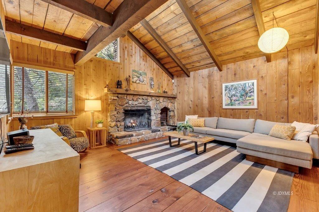 24631 Upper Rim Rock Road Idyllwild, CA 92549 - Photo 6 of 34 a living room with furniture a fireplace and a large window