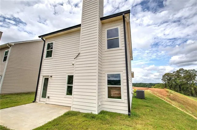 a view of a white house with a yard