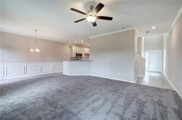 a view of an empty room with a ceiling fan