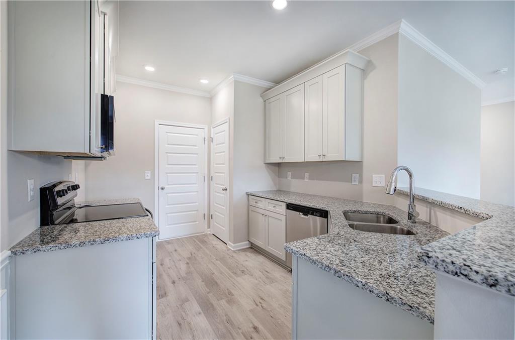 266 Eva Way Cartersville, GA 30121 - Photo 6 of 20 a kitchen with a sink stove and cabinets