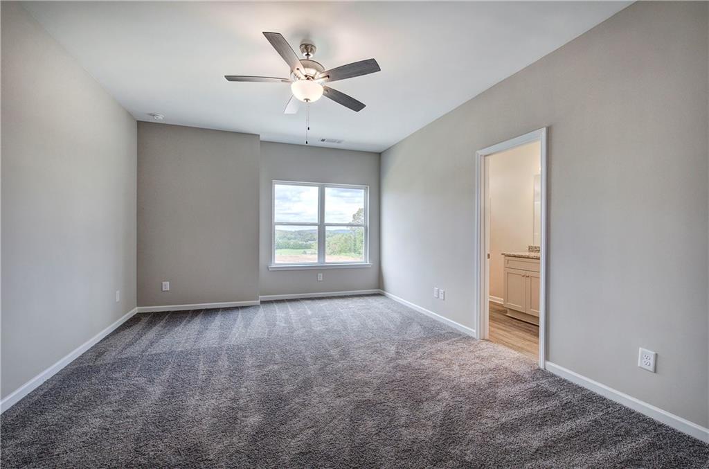 266 Eva Way Cartersville, GA 30121 - Photo 10 of 20 an empty room with windows and fan