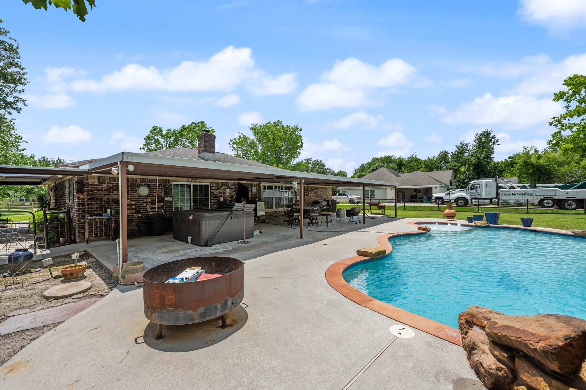 15602 Fir Road Santa Fe, TX 77517 - Photo 32 of 42 Expansive backyard retreat featuring a sparkling in-ground pool, oversized covered patio, and multiple spaces for outdoor dining and entertaining. The setup is ideal for relaxing weekends, gatherings, and enjoying the spacious yard.