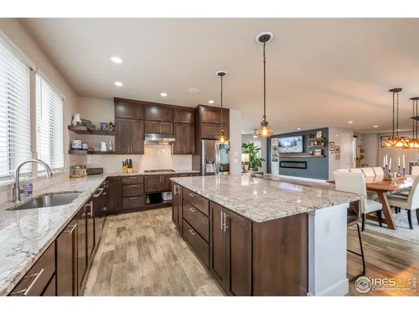 a kitchen with stainless steel appliances granite countertop a sink counter space and a stove