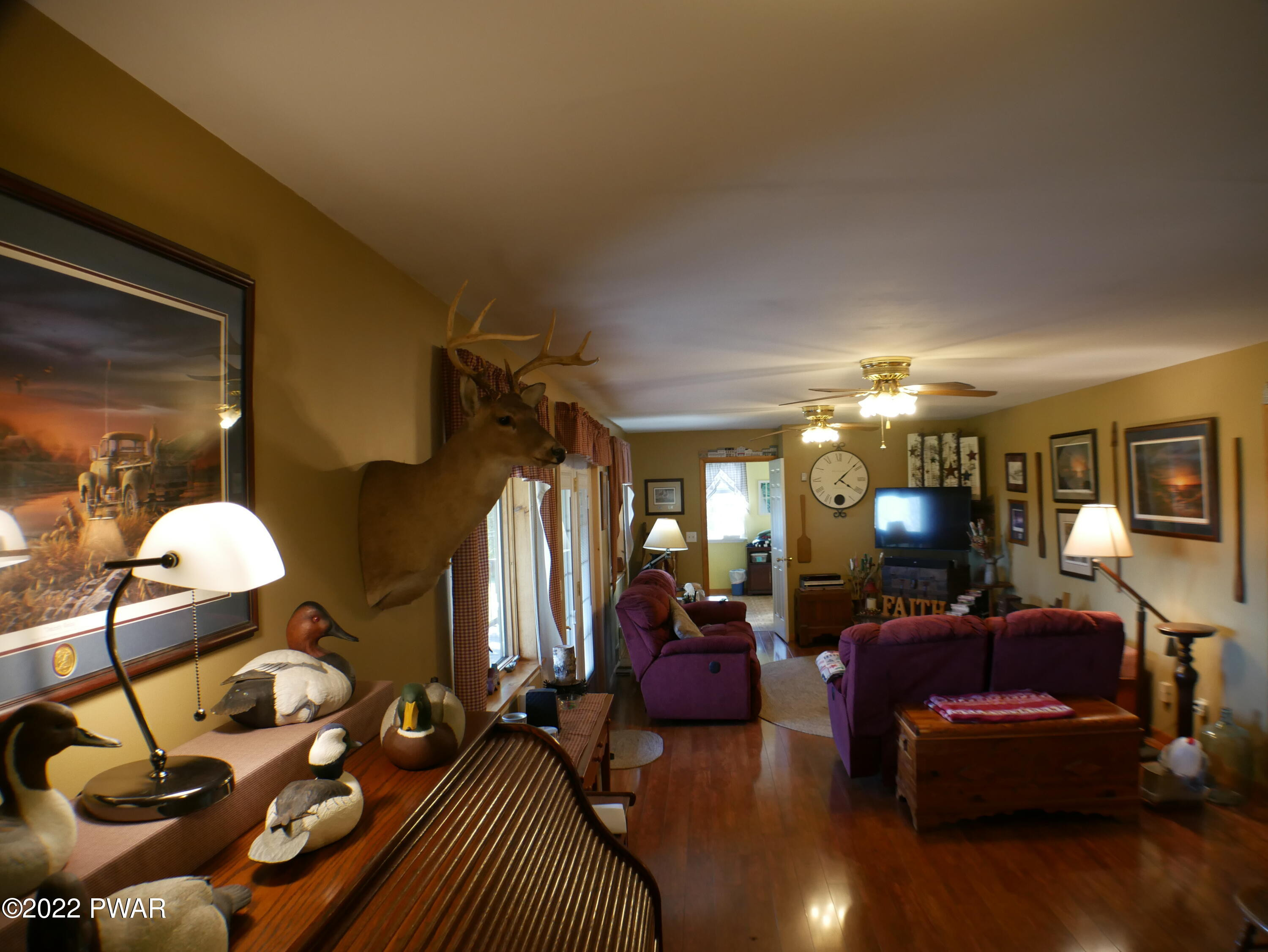 1259 Dougherty Road Meshoppen, PA 18630 - Photo 19 of 61 a living room with furniture a lamp and a fireplace