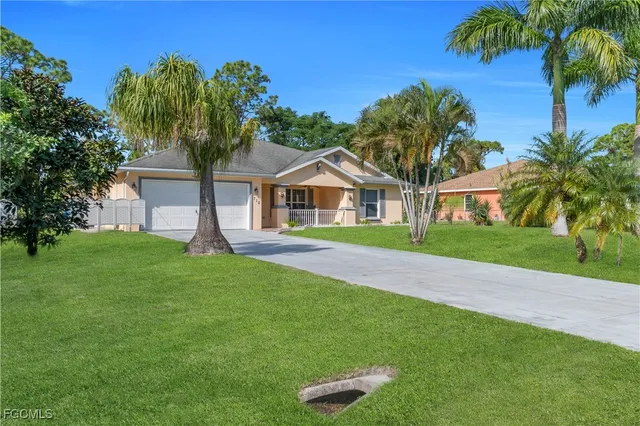 a house with green field in front of it