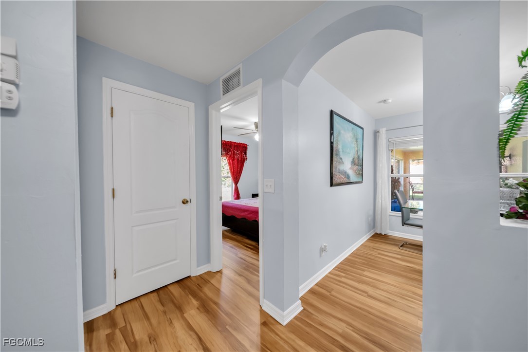 710 Homestead Road South Lehigh Acres, FL 33974 - Photo 13 of 38 a view of a hallway view with wooden floor and staircase