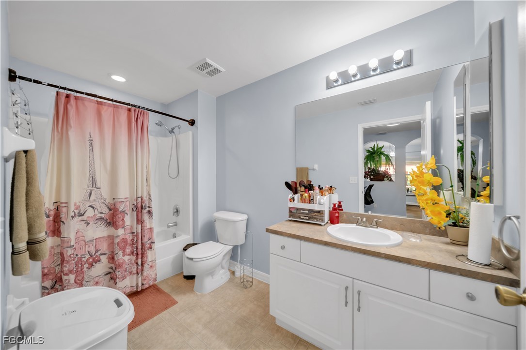 710 Homestead Road South Lehigh Acres, FL 33974 - Photo 15 of 38 a bathroom with a sink vanity mirror and toilet