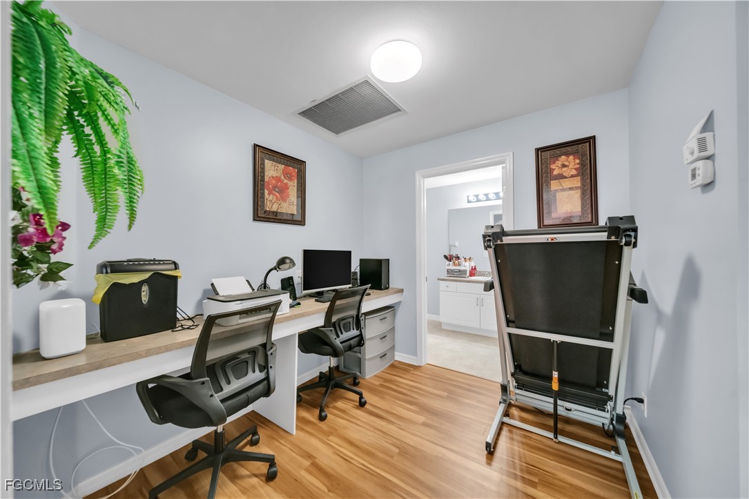 710 Homestead Road South Lehigh Acres, FL 33974 - Photo 20 of 38 a view of a workspace with furniture and a window