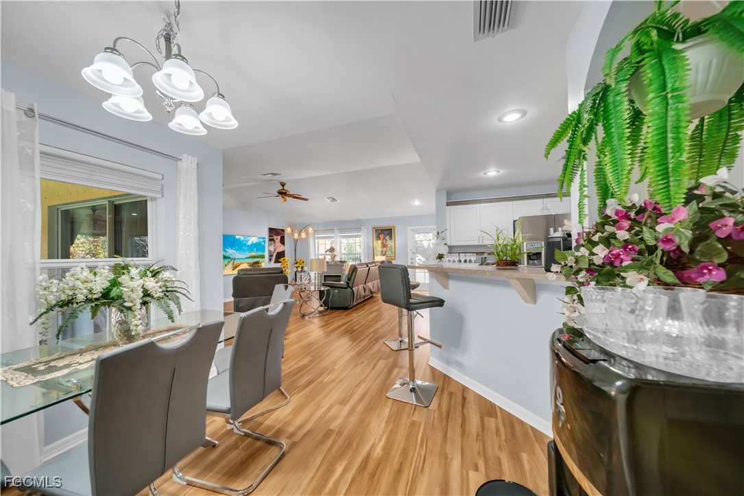 710 Homestead Road South Lehigh Acres, FL 33974 - Photo 21 of 38 a living room with furniture and a chandelier