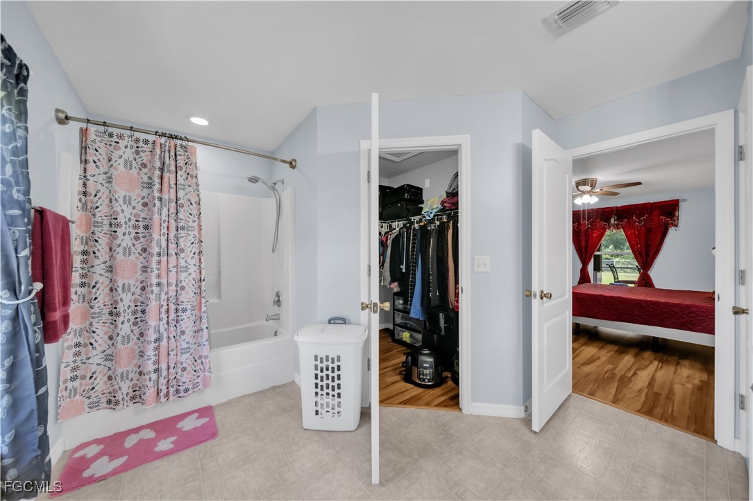 710 Homestead Road South Lehigh Acres, FL 33974 - Photo 26 of 38 a view of walk in closet with clothes and shoes