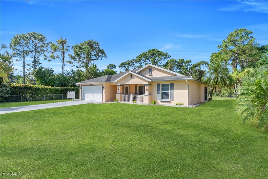 710 Homestead Road South Lehigh Acres, FL 33974 - Photo 34 of 38 a view of a house with a yard