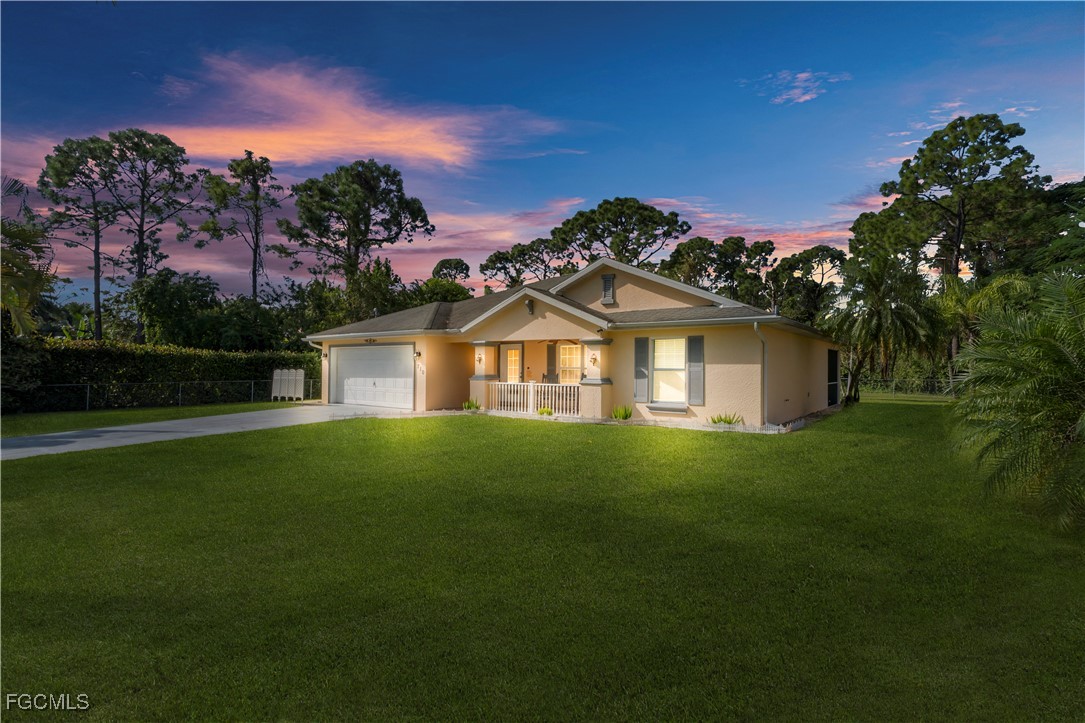 710 Homestead Road South Lehigh Acres, FL 33974 - Photo 37 of 38 a front view of a house with a garden
