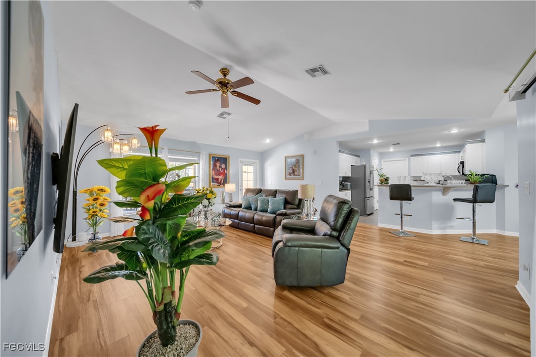 710 Homestead Road South Lehigh Acres, FL 33974 - Photo 6 of 38 a living room with furniture potted plant and a flat screen tv