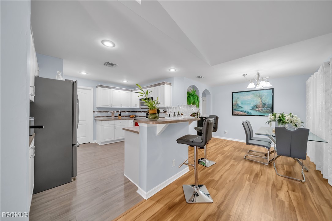 710 Homestead Road South Lehigh Acres, FL 33974 - Photo 9 of 38 a living room with dining room and wooden floor