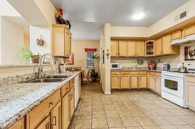 a kitchen with stainless steel appliances granite countertop a sink and cabinets