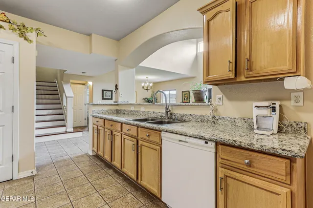 a kitchen with stainless steel appliances granite countertop a sink and cabinets